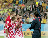 Croatia players argue after being given a penalty by referee Yuichi Nishimura from Japan during the group A World Cup soccer match between Brazil and Croatia, the opening game of the tournament, in the Itaquerao Stadium in Sao Paulo, Brazil, Thursday, June 12, 2014. (AP Photo/Ivan Sekretarev)