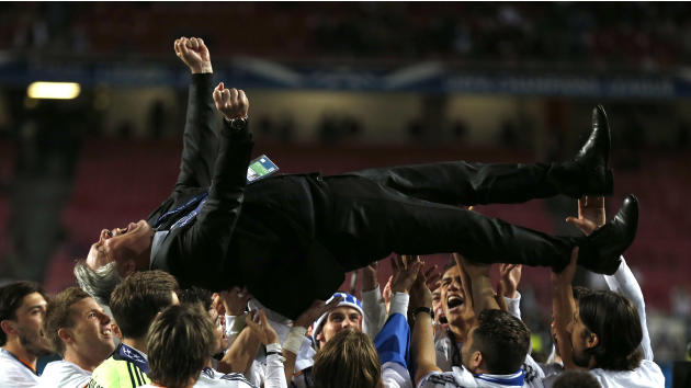 Real's coach Carlo Ancelotti, is lifted in the air, after his team won the Champions League final soccer match between Atletico Madrid and Real Madrid in Lisbon, Portugal, Saturday, May 24, 2014