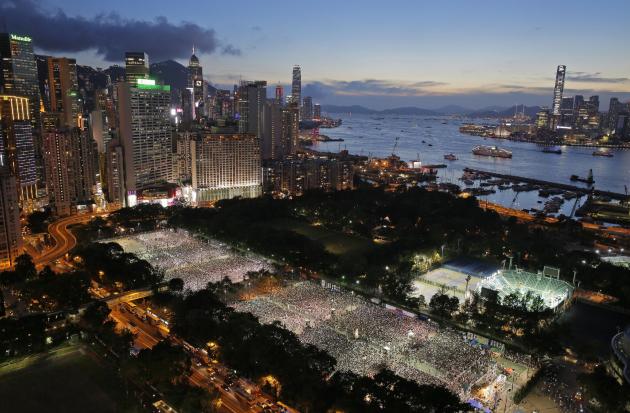 Tens of thousands of people attend a candlelight vigil at Victoria Park in Hong Kong Wednesday, June 4, 2014, to mark the 25th anniversary of the June 4th Chinese military crackdown on the pro-democra
