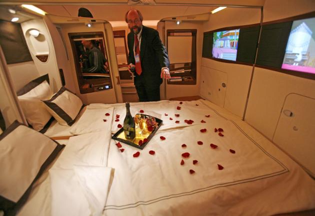 File photo of a journalist inspecting a double bed first class suite during a media tour of the Airbus A380 superjumbo after it landed at Singapore's Changi Airport