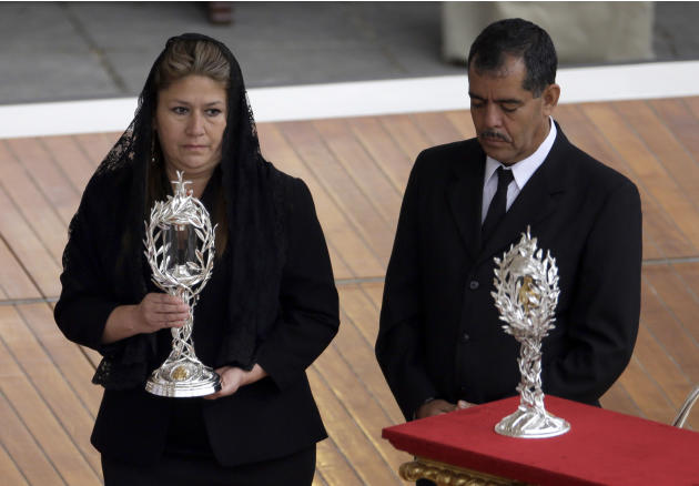 Floribeth Mora, a Costa Rican woman whose inoperable brain aneurysm purportedly disappeared after she prayed to John Paul II, carries a relic of Pope John Paul II during a solemn ceremony led by Pope