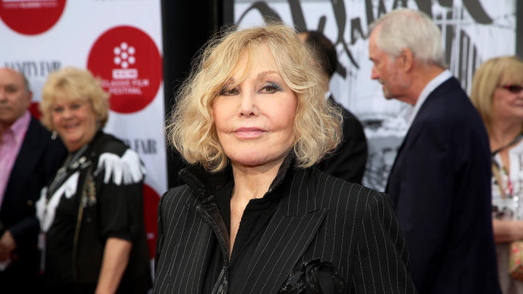 FILE - In this Thursday, April 10, 2014 file photo, Kim Novak arrives at the 2014 TCM Classic Film Festival&#39;s Opening Night Gala at TCL Chinese Theatre in Los Angeles. Novak says that cruel jabs about how she looked during the Oscar March 2 ceremony amounted to bullying that left her at first crushed and then determined to speak out in protest. Turner Classic Movies host Robert Osborne agreed to discuss it during an interview with Novak that preceded a festival screening last Saturday, April 12, 2014, of her film &quot;Bell, Book and Candle.&quot; (Photo by Annie I. Bang /Invision/AP, file)