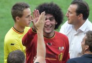 Belgium's Marouane Fellaini (C) and coach Marc Wilmots (R) celebrate after they won 2-1 during their Group H match against Algeria, at Mineirao Stadium in Belo Horizonte, during the FIFA World Cup, on June 17, 2014