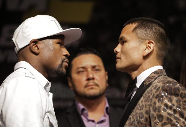 Boxers Floyd Mayweather Jr., left, and Marcos Maidana pose during a press conference Wednesday, Sept. 10, 2014, in Las Vegas. The two are scheduled to fight in a welterweight title fight Saturday in L