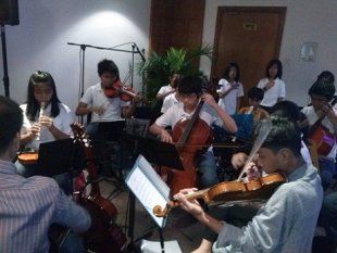 The Kolisko Waldorf School Music Ensemble performs at the exhibit of recovery efforts in Yolanda-hit areas.