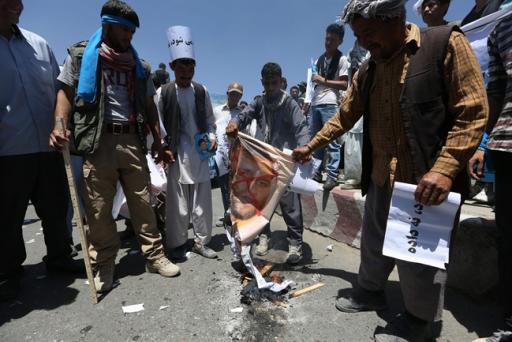 Supporters of presidential candidate Abdullah Abdullah burn a picture of Afghanistan's Independent Election Commission director Ziaulhaq Amarkhil during a protest in Kabul, Afghanistan, Saturday, June 21, 2014. Former Foreign Minister Abdullah, who is running against Ashraf Ghani Ahmadzai, a former finance minister, has accused electoral officials and others of trying to rig the June 14 vote against him. (AP Photo/Rahmat Gul)