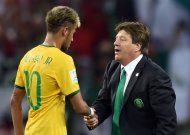 Brazil's Neymar speaks with Mexico's coach Miguel Herrera after their Group A match, at Castelao Stadium in Fortaleza, during the FIFA World Cup, on June 17, 2014