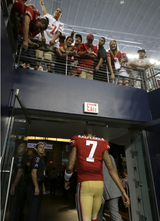San Francisco 49ers quarterback Colin Kaepernick (7) walks off the field under fans after the NFL football game against the Dallas Cowboys Sunday, Sept. 7, 2014, in Arlington, Texas. (AP Photo/LM Oter