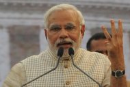 Bharatiya Janata Party (BJP) prime ministerial candidate Narendra Modi gestures to signify over 300 seats won for the BJP and its allies during a public rally after his victory in Vadodara on May 16, 2014