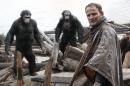 This photo released by Twentieth Century Fox Film Corporation shows Jason Clarke, as Malcolm, foreground, and, background from left, Andy Serkis, as Caesar; Toby Kebbell, as Koba; and Karin Konoval, as Maurice; in a scene from the film, "Dawn of the Planet of the Apes." (AP Photo/Twentieth Century Fox Film Corporation)