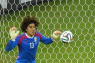 Mexico's goalkeeper Guillermo Ochoa saves an attempt at goal during their Group A match against Brazil, at Castelao Stadium in Fortaleza, during the FIFA World Cup, on June 17, 2014