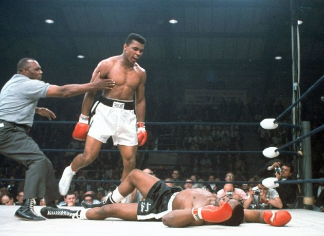 ARCHIVO - En esta imagen de archivo del 25 de mayo de 1965, el campeón de peso completo Muhammad Ali es retenido por el árbitro Joe Walcott, a la izquierda, después de que Ali noqueara a su rival Sonny Liston en el primer asalto de su combate por el título en Lewiston, Maine. Ali, el indómito campeón peso completo cuyos demoledores golpes y avasalladora personalidad transformaron el deporte y le hicieron una superestrella mundial, ha fallecido, informó su familia. Tenía 74 años. (AP Foto/Archivo)