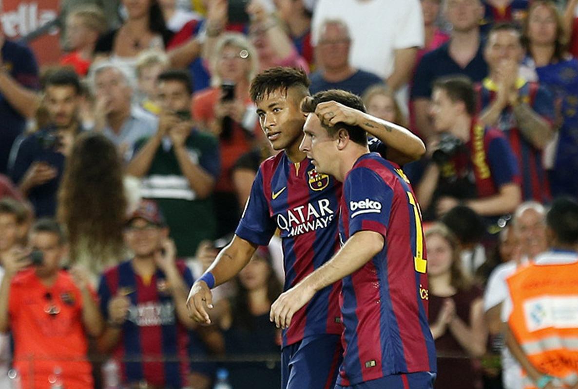 Barcelona's Messi celebrates his goal with teammate Neymar against Mexican club Leon during their Joan Gamper Trophy soccer match at Nou Camp...