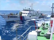 This image taken on June 1, 2014 from Vietnam Coast Guard and released on June 5, 2014 shows the a Chinese Coast Guard vessel (left) chasing a Vietnamese ship in disputed waters in the South China Sea