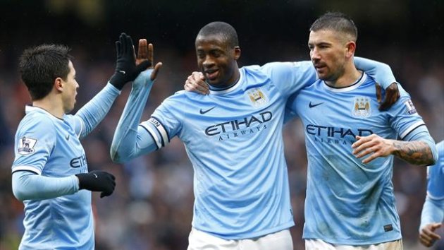 Manchester City players congratulate Yaya Toure, who scored a hat-trick against Fulham (Reuters)