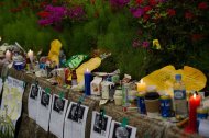 Candles, beverages, food and messages stand on a makeshift memorial at the main gate of Danwon high school in Ansan on April 27, 2014