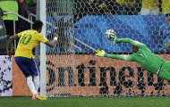Brazil's Neymar, left, scores his sides second goal from the penalty spot during the group A World Cup soccer match between Brazil and Croatia, the opening game of the tournament, in the Itaquerao Stadium in Sao Paulo, Brazil, Thursday, June 12, 2014. (AP Photo/Felipe Dana)