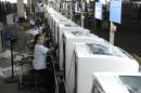 Employees assemble washing machines on the production line inside a factory of Hefei Rongshida Sanyo Electric in Hefei