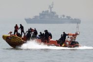 South Korean rescue workers operate around the area where capsized passenger ship Sewol sank during an rescue operation in Jindo April 23, 2014. REUTERS/Yonhap