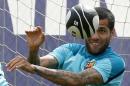 Barcelona's Dani Alves plays with a rugby ball   during a training session near Barcelona