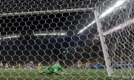 Croatia's goalkeeper Stipe Pletikosa deflects the ball as Brazil's Neymar scores his side's 2nd goal from the penalty spot during the group A World Cup soccer match between Brazil and Croatia, the opening game of the tournament, in the Itaquerao Stadium in Sao Paulo, Brazil, Thursday, June 12, 2014. (AP Photo/Andre Penner)
