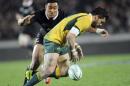 Australia's Adam Ashley-Cooper drops the ball under pressure from New Zealand's Julian Savea in their international test Bledisloe Cup rugby match at Eden Park in Auckland, New Zealand, Saturday, Aug. 23 2014. (AP Photo/SNPA, Ross Setford) NEW ZEALAND OUT
