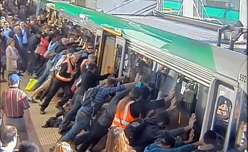 Capture d'écran d'une vidéo publiée le 6 août 2014 par le service des transports publics d'Australie-Occidentale et montrant des passagers tentant de faire basculer un train pour dégager un voyageur dont la jambe est coincée