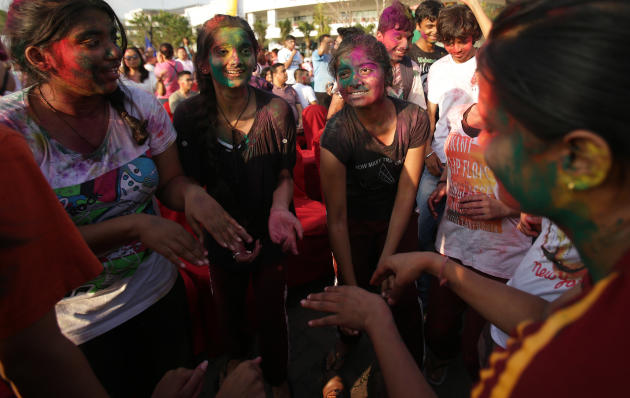 Indian nationals dance to celebrate the Holi festival in suburban Pasay, south of Manila, Philippines, on Sunday March 16, 2014. The event is led by Indian nationals as they mark Holi, a Hindu spring 