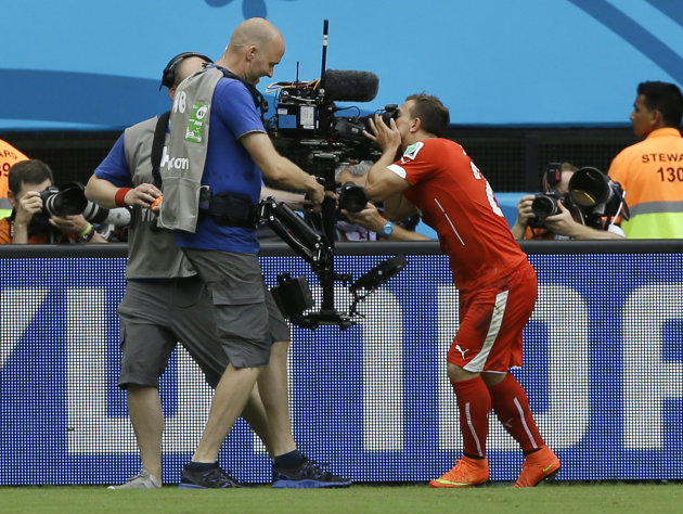 Switzerland&amp;#39;s Xherdan Shaqiri kisses a TV camera as he celebrates after scoring the opening goal during the group E World Cup soccer match between Honduras and Switzerland at the Arena da Amazonia in Manaus, Brazil, Wednesday, June 25, 2014. (AP Photo/Kirsty Wigglesworth)