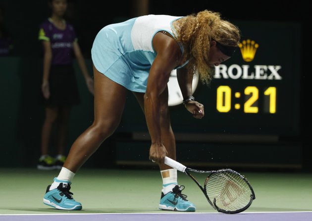 Serena Williams of the U.S. smashes her second racket during her WTA Finals singles semi-finals tennis match against Caroline Wozniacki of Denmark, at the Singapore Indoor Stadium October 25, 2014. REUTERS/Edgar Su (SINGAPORE - Tags: SPORT TENNIS TPX IMAGES OF THE DAY)