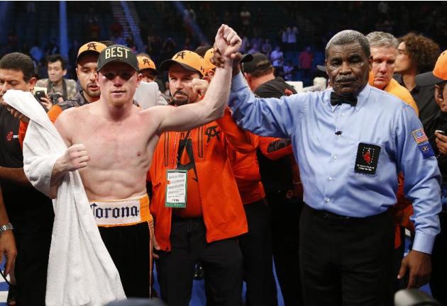 Canelo Alvarez, of Mexico, is declared the winner over Erislandy Lara, of Cuba after their super welterweight fight, Saturday, July 12, 2014, in Las Vegas. (AP Photo/Eric Jamison)