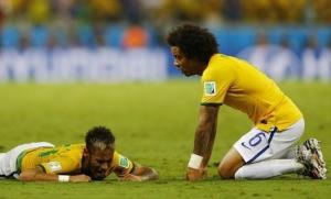 Brazil's Marcelo reacts next to teammate Neymar after Neymar was injured in a challenge against Colombia during their 2014 World Cup quarter-finals at the Castelao arena in Fortaleza