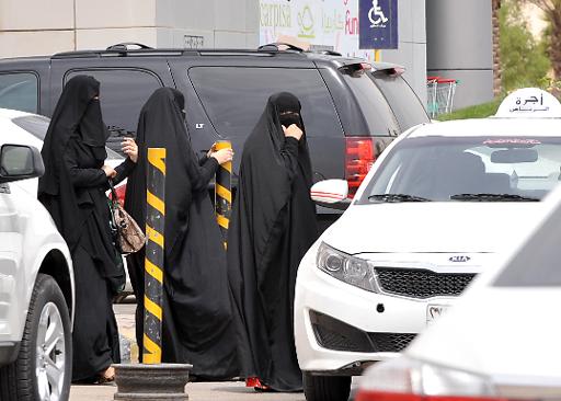 Saudi women leave a mall after shopping in the capital Riyadh, on March 29, 2014