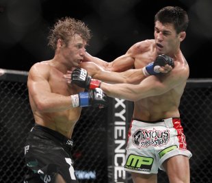 Urijah Faber and Dominick Cruz trade blows during their 2011 fight. (AP)
