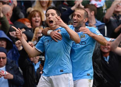 Manchester City's French midfielder Samir Nasri (L) celebrates with defender Pablo Zabaleta at the Etihad Stadium in Manchester on May 11, 2014