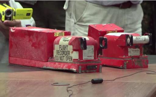 AFP TV video grab shows the two black boxes recovered from the crash site of the MH17 jet being handed over to Malaysian officials during a press conference in Donetsk on July 22, 2014