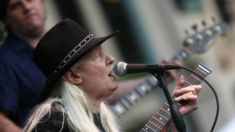 FILE - In this Friday, June 19, 2009 file photo, Johnny Winter plays during the Canton Blues Festival 2009 in downtown Canton, Ohio. Texas blues icon Johnny Winter, who rose to fame in the late 1960s and &#39;70s with his energetic performances and recordings that included producing his childhood hero Muddy Waters, died in Zurich, Switzerland on Wednesday, July 16, 2014. He was 70. (AP Photo/The Repository, Bob Rossiter) MANDATORY CREDIT