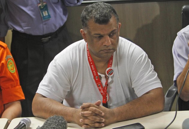 AirAsia Group CEO Tony Fernandes ponders during a press conference at Juanda International Airport in Surabaya, East Java, Indonesia, Sunday, Dec. 28, 2014. A massive sea search was underway for an AirAsia plane that disappeared Sunday while flying from Indonesia to Singapore through airspace possibly thick with dense storm clouds, strong winds and lightning, officials said. (AP Photo/Trisnadi)