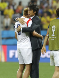 South Korea head coach Hong Myung-bo, right, comforts his player Son Heung-min, left, after the group H World Cup soccer match between South Korea and Belgium at the Itaquerao Stadium in Sao Paulo, Brazil, Thursday, June 26, 2014. Belgium beat South Korea 1-0 to top Group H of World Cup. South Korea was eliminated. (AP Photo/Lee Jin-man)