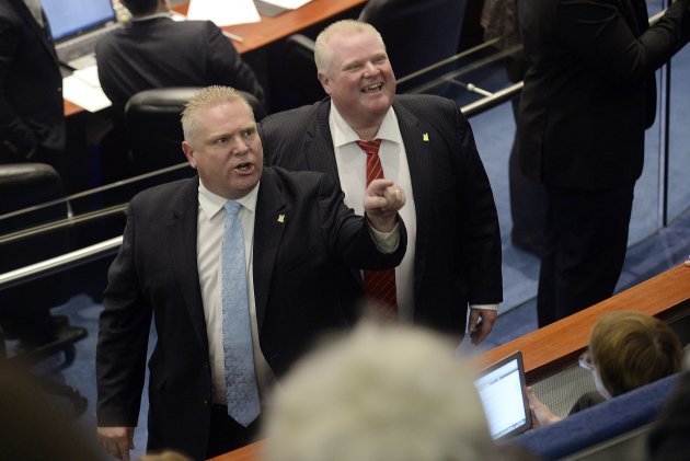 Doug Ford and Mayor Rob Ford react to the gallery at City Hall in Toronto November 18, 2013. (Reuters)