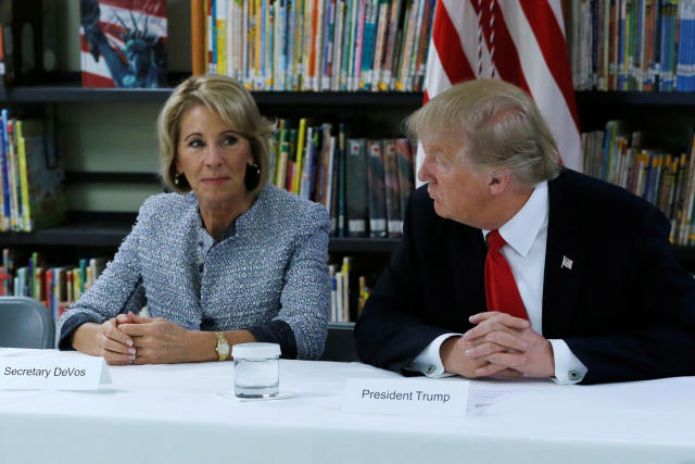 U.S. President Donald Trump (R) and Education Secretary Betsy DeVos (L) meet with parents and teachers at Saint Andrew Catholic School in Orlando, Florida, U.S. March 3, 2017. REUTERS/Jonathan Ernst