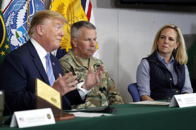 Lt. Gen. Todd Semonite, commanding General of the U.S. Army corps of Engineers , center and Homeland Security Secretary Kirstjen Nielsen, listens as President Donald Trump participates in a roundtable on immigration and border security at the U.S. Border Patrol Calexico Station in Calexico, Calif., Friday April 5, 2019. Trump headed to the border with Mexico to make a renewed push for border security as a central campaign issue for his 2020 re-election. (AP Photo/Jacquelyn Martin)