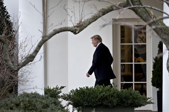 President Donald Trump walks out of the Oval Office on Feb. 16.  (Bloomberg via Getty Images)
