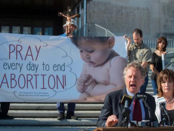 Louisiana senator John Milkovich (left) and Republican Valarie Hodges speak after the Louisiana House passed Mr Milkovich's 'fetal heartbeat' bill that would ban abortions at about six weeks of pregnancy, if upheld by the courts. (AP)