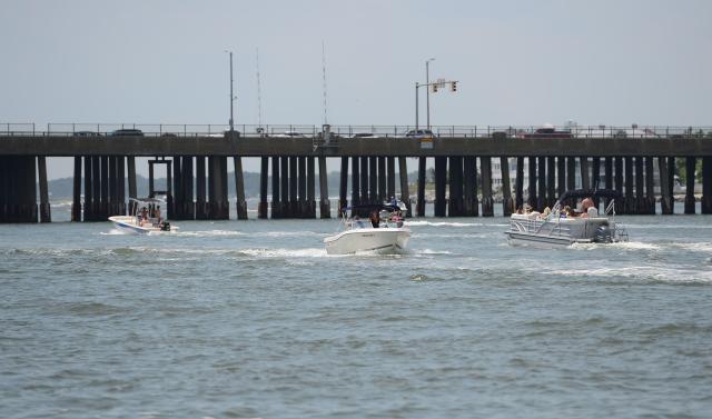 Boats travel from the bay to the ocean underneath the Route 50 bridge in Ocean City.