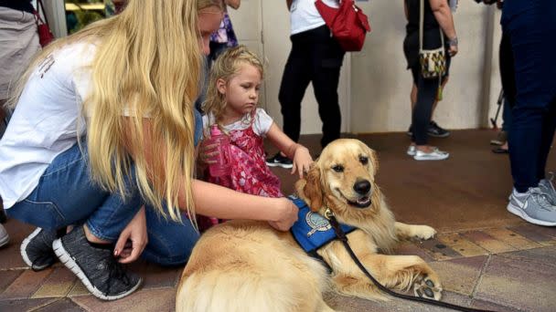 PHOTO: From left, Emmy Halulko, 13, and her sister Evie, 5, pet Jacob, a Lutheran Church Charities comfort dog while at the Parkridge Church in Coral Springs, Fla, Feb. 15, 2018, for a community prayer vigil for the Parkland high school shooting victims. (Eric Hasert/TCPalm via USA Today Network)