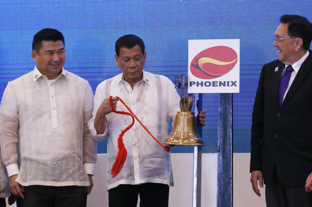 Philippine President Rodrigo Duterte, center, and Dennis Uy, left, CEO of Phoenix Petroleum, and at right is Jose Pardo, chairman of the Philippine Stocks Exchange. (AP Photo/Bullit Marquez)