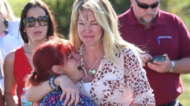 PHOTO: Women embrace in a waiting area for parents of students after a shooting at Marjory Stoneman Douglas High School in Parkland, Fla., Feb. 14, 2018. (Joel Auerbach/AP)