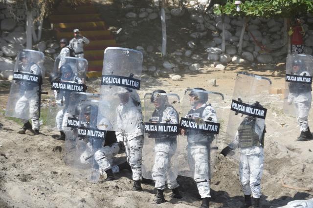 Members of Mexico's National Guard take position as Central American migrants - mostly Hondurans travelling in caravan to the US- crossed the Suchiate River, the natural border between Tecun Uman in Guatemala and Ciudad Hidalgo in Mexico, on January 20, 2020. - Hundreds of Central Americans from a new migrant caravan tried to enter Mexico by force Monday by crossing the river that divides the country from Guatemala, prompting the National Guard to fire tear gas, an AFP correspondent said. (Photo by Johan ORDONEZ / AFP) (Photo by JOHAN ORDONEZ/AFP via Getty Images)