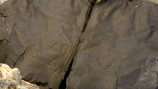 A charred bible found after the Peshtigo Fire of 1871. It was petrified from the intense heat and found opened to the pages containing Psalms 106 and 107. (AccuWeather / Blake Naftal)